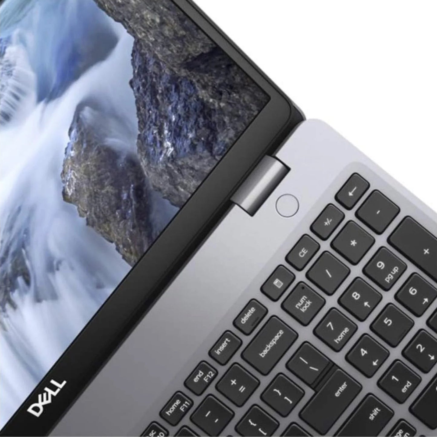 Laptop displaying a mountainous landscape on the screen with a focus on the keyboard.