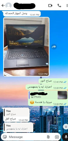 Laptop on a desk with a scenic display, shown in a messaging app interface.