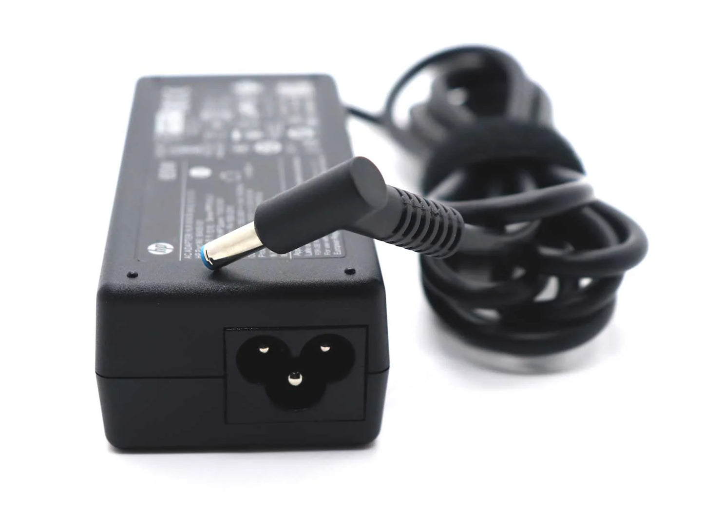 Black laptop charger with a coiled cable on a white background
