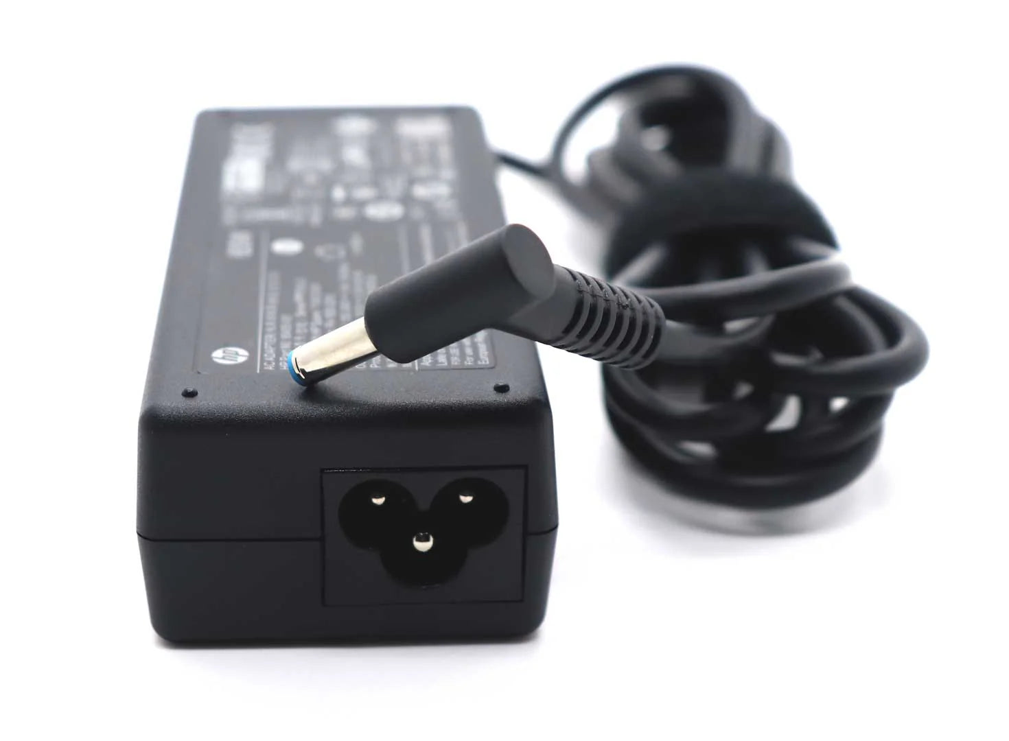 Black laptop charger with a coiled cable on a white background