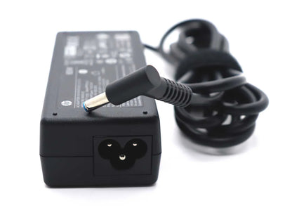 Black laptop charger with a coiled cable on a white background